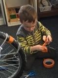 Older 3s using tools to work on bike